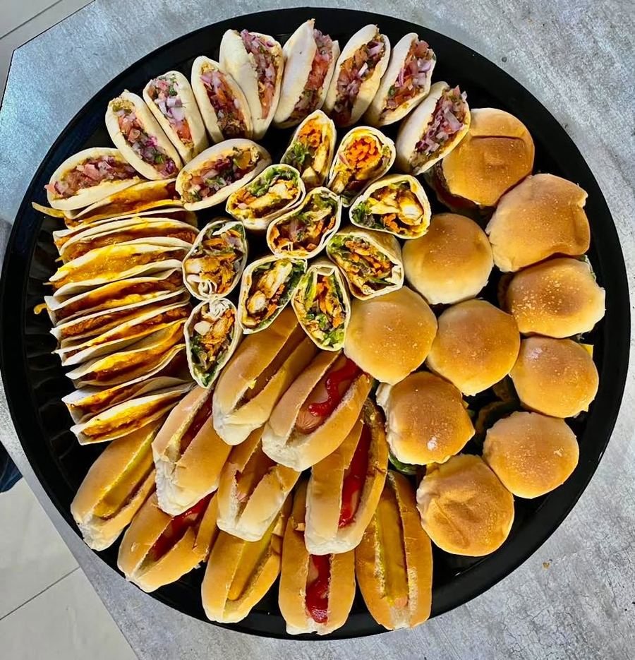 Snack platter with pita pockets, chicken wraps, sliders, mini boerie rolls and mini tacos